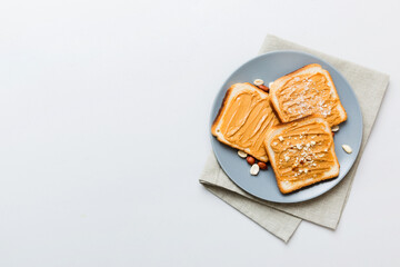 Peanut butter sandwiches or toasts on light table background.Breakfast. Vegetarian food. American cuisine top view vith copy space