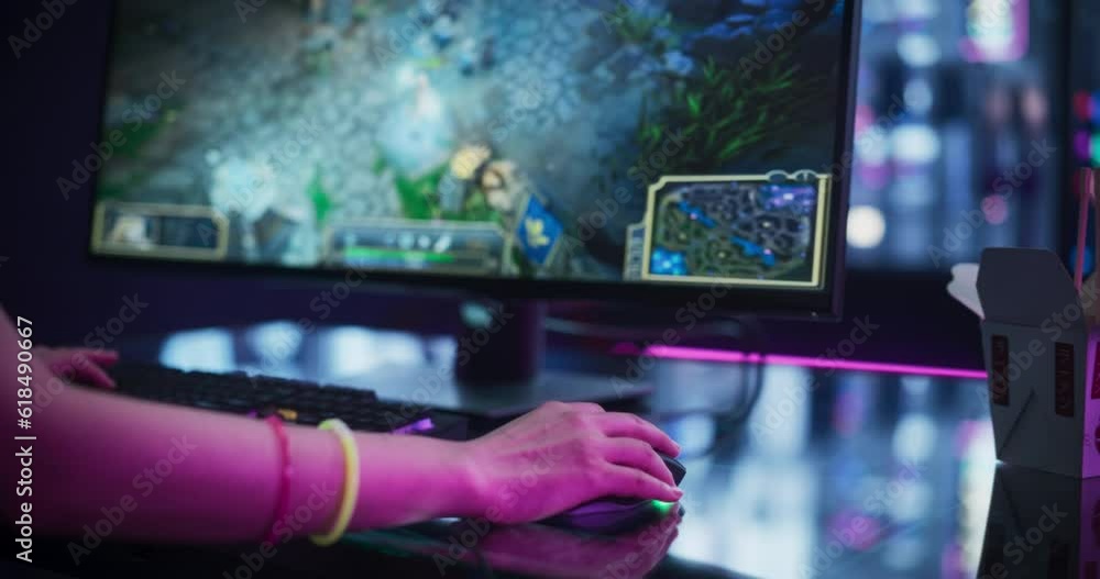 Poster close up footage of a female playing online multiplayer strategy video game on a computer, using a m