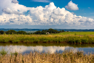 Landscape with a view of the dam and a rural property, located in Brazil