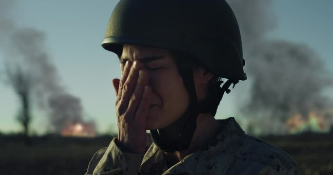 Slow Motion Close Up Portrait of Female Soldier in Distress in a War Zone Field. Strong Woman in Military Camouflage Uniform Pushing Through Emotions from the Horrors of the Battlefield