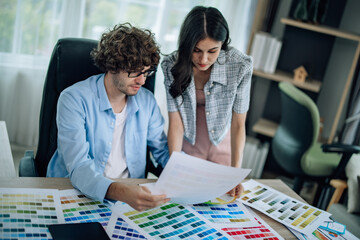 Fototapeta premium Prototype engineers collaborate to select Pantone colors for mobile apps, optimizing user experience. Brainstorming, communicating to ensure innovative and scalable prototypes meet user requirements.