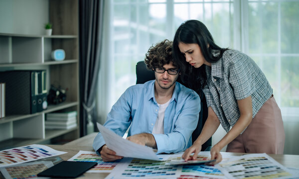 Prototype engineers collaborate to select Pantone colors for mobile apps, optimizing user experience. Brainstorming, communicating to ensure innovative and scalable prototypes meet user requirements.