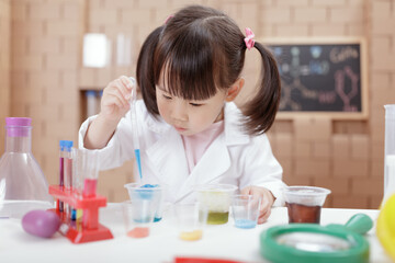 young girl was doing  science experiment at home
