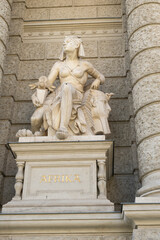 Fototapeta na wymiar Sculpture woman and sphinx on a building in Austria in Vienna, text in German Afrika