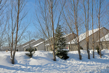 Fototapeta na wymiar A Row Of Condominium Roofs In Winter Snow