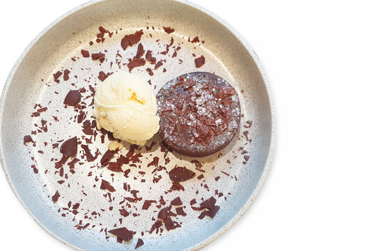 Chocolate lava cake and Ice cream with chocolate flakes on white background.