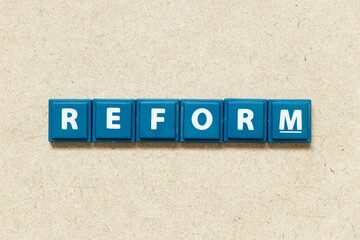 Tile alphabet letter in word reform on wood background