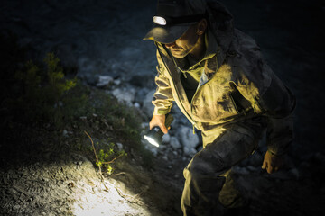 Emergency Rescue Search Team Member with Flashlights at Night - obrazy, fototapety, plakaty