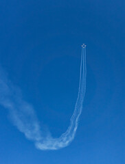 Flight of planes rises vertically in the blue sky