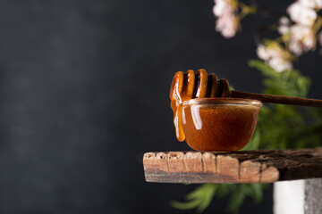 Manuka honey dripping from a wooden spoon