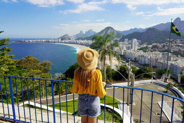 Tourism in Brazil. Back view of young traveler woman enjoying Rio de Janeiro cityscape with...