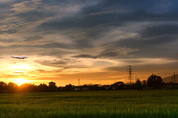 Commercial airplane above sea with sunset in summer season over beautiful scenery background, Concept business travel and transportation summer vacation travel.
