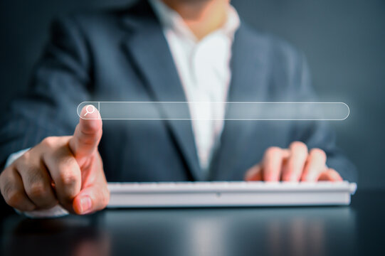 Browsing Internet Data Information Search engine with businessman background. Man clicking internet search bar accessing homepage on computer touch screen. Digital Networking Concept. Copy space.