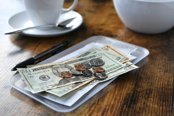 Paying for your bill tab at a restaurant cafe with cash money. - obrazy, fototapety, plakaty