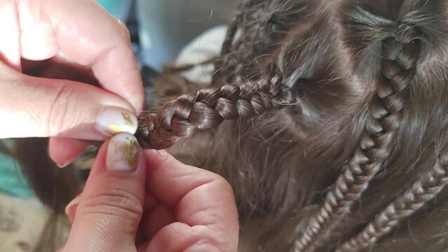 the girl is braided with African braids. hairstyle close-up.