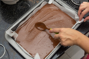 woman preparing brownie at home. homemade chocolate brownie