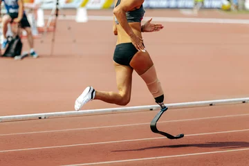 Foto op Plexiglas Treinspoor female para athlete on prosthetic leg running track stadium, summer para athletics championships
