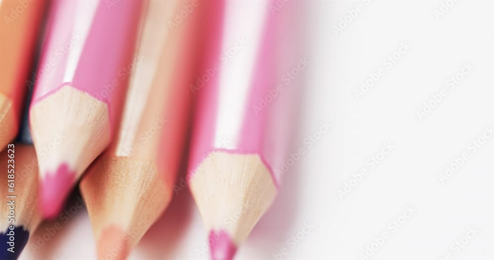 Poster close up of sharpened multi coloured pencils with copy space on white background