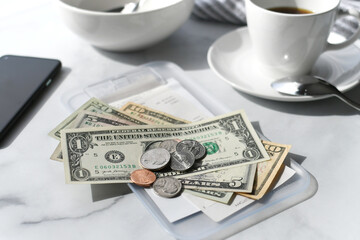 Paying for your bill tab at a restaurant cafe with cash money.