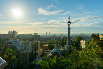 Fototapeta na wymiar City view with a clear blue sky from the top of Park Guell in Barcelona. Park Guell is one of the famous architect Antoni Gaudi's major works. It is among the most popular tourist attractions.