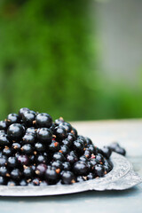 black currants in a vintage metal tray