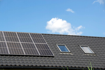 Fototapeta premium House roof with photovoltaic modules.