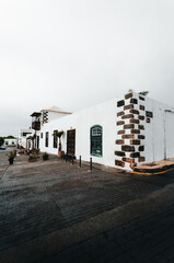 Photo of traditional house in Lanzarote - Canary Islands. Vertial photo of cozy white building in Teguise - Lanzarote.