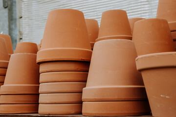 Stacked terracotta flower pots on the shelves at the garden center