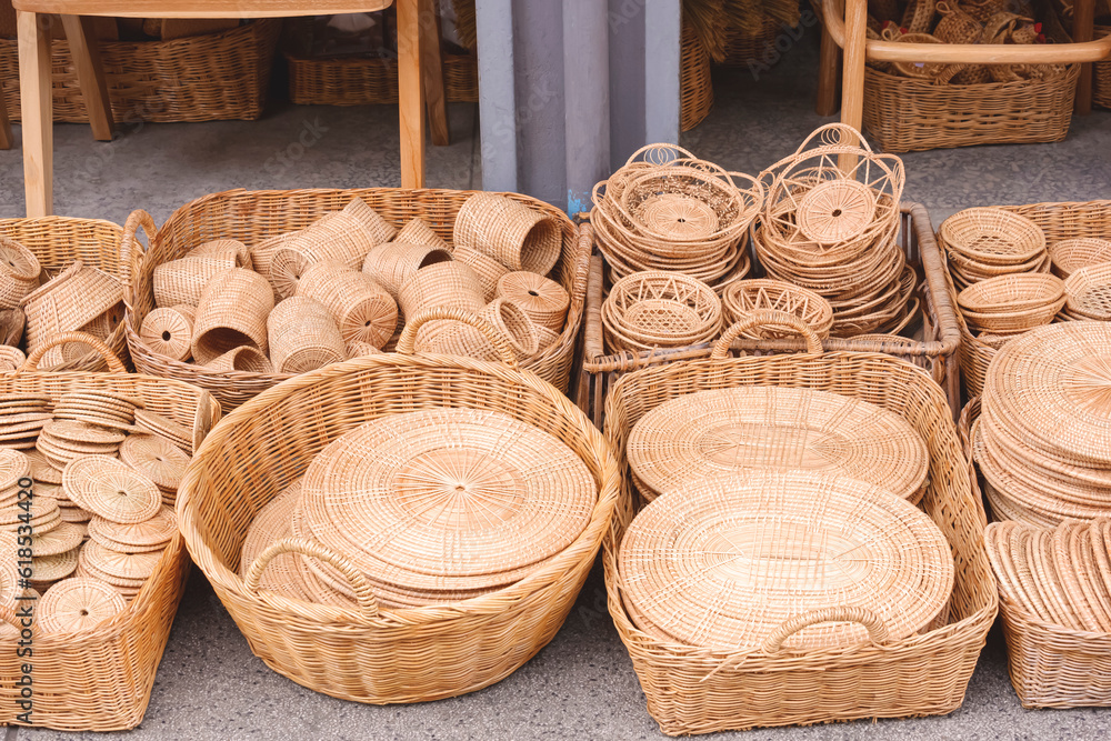 Wall mural Group of many various handmade wicker products for sale on the floor in street market at Thailand