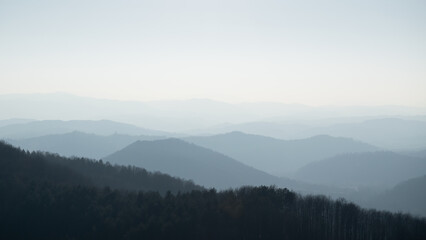 Fototapeta na wymiar Mountain layers in haze, view from mountain Ljubic near Prnjavor