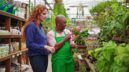 Elderly Black Woman Assisting Customer in Horticulture Store. A Confident Senior Lady Guiding Plant Purchase at a Local Flower Shop