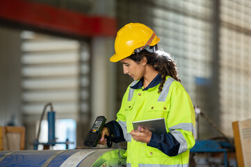 young woman engineer in uniform inspection warehouse and check control heavy machine construction...