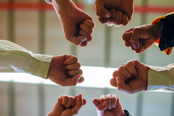 Group of young Engineer United stack hands or join hand teamwork together with Spirit diversity solidarity team Partner in metal sheet factory. Joins hands together teamwork meetings empower.
