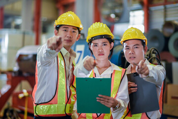 Header mentor and young employees trainee stand for operating machine looking see through camera monitor and point finger with angry serious mood. foreman team young engineer angry serious mood