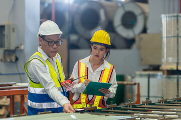 Factory apprenticeship. Man mentor teaching Female employees trainee operating machine looking...