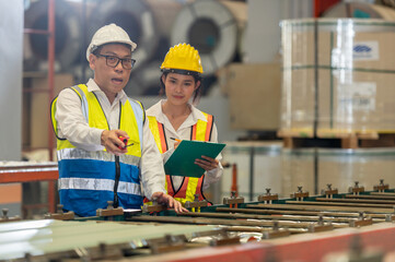 Factory apprenticeship. Man mentor teaching Female employees trainee operating machine looking...