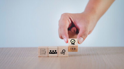 Businessman pressing his finger on a wooden cube Certification and Standardization Process The iso...