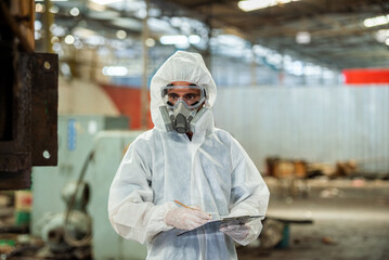 Male inspector in chemical PPE protective suit investigate chemical gas leak spill with safety face...