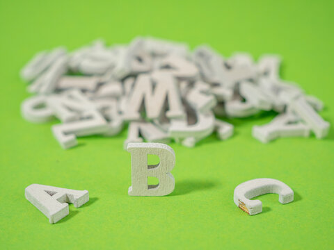 Wooden letters on a green background. Wooden letters abc concept of school and learning.