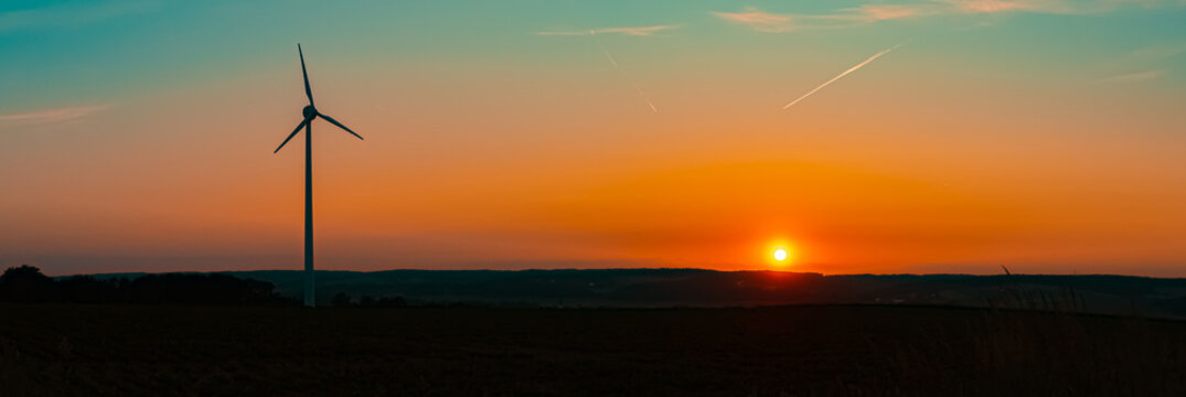 Sunset with wind power plant silhouettes near Kugl, Simbach, Dingolfing-Landau, Bavaria, Germany