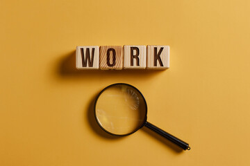 The word work is inscribed in wooden cubes. blue background.