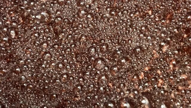 Bubbles formed on the surface of wine must caused by the residual carbon dioxide produced during the fermentation activity of yeast. Textures, Close up