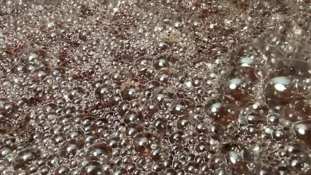Bubbles formed on the surface of wine must caused by the residual carbon dioxide produced during the fermentation activity of yeast. Textures, Close up
