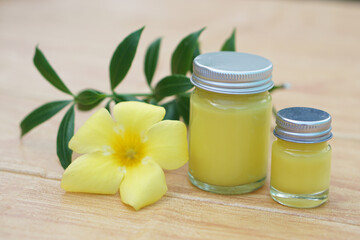 Bottles of homemade Thai herbal ointment.Decorated with yellow flower.Concept, Thai local wisdom to use  fragrant medicinal herbs to make inhaler and massage balm.      