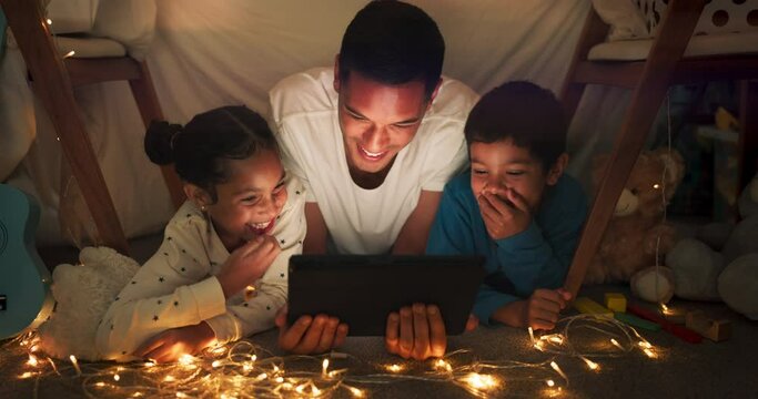 Comedy, tablet and dad with children in a tent house streaming internet video, show or movie online in the night. Dark, digital and parent or father relax with kids watching funny app in the evening