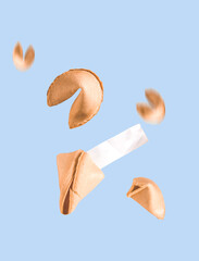 Fortune cookies fly on a blue background. Minimal art mockup for prediction.