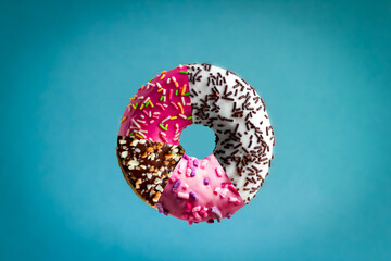 Donuts with different glaze and flavour collage on blue background.Sweet junk food poster.