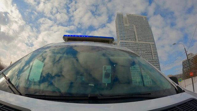 camera on hood of moving mbulance car, frontal view of windshield and silhouette of paramedics