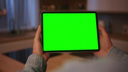 Shot of male hands using digital tablet. Man working with gadget, tapping on green screen.Chroma key concept. Indoors. Blurred background. Mock up display. Communication, networking - Powered by Adobe