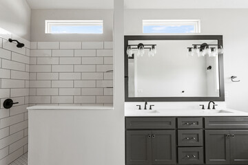 Brand new build, contemporary bathroom with subway tiles, drop in tub and brand new marble flooring and marble counter tops. 